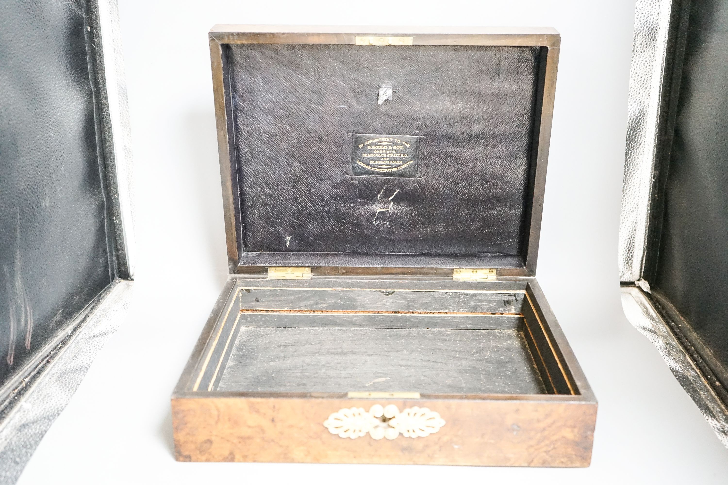A late 19th/early 20th century brass mounted burr walnut box, label to interior reading ‘E.Gould & Son. Chemists. 32. Moorgate street. E.C. And 20 Bishops road. W. By appointment to the London Homeopathic Hospital.’